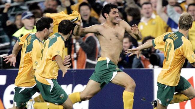 WIRE: Socceroos (L-R) Tony Vidmar, Scott Chipperfield, John Aloisi and Vincent Grella celebrate after defeating Uruguay on penalties during their second leg World Cup qualifier, Australia v Uruguay at Sydney's Telstra Stadium, 16/11/2005. Australia booked a World Cup 2006 finals berth for the first time in 31 years.