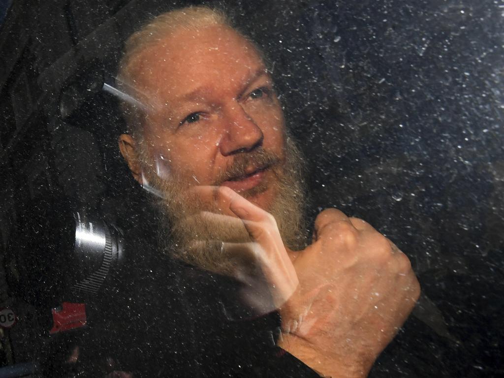 Assange gives the thumbs up as he arrives at court. He was later remanded in custody until May 2.