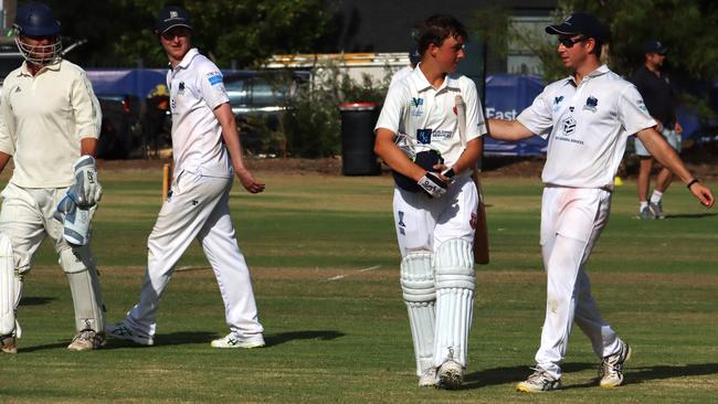 Nick Critchley is congratulated by Brighton District players after making 72 not out for Bentleigh. Picture: Brian Nankervis