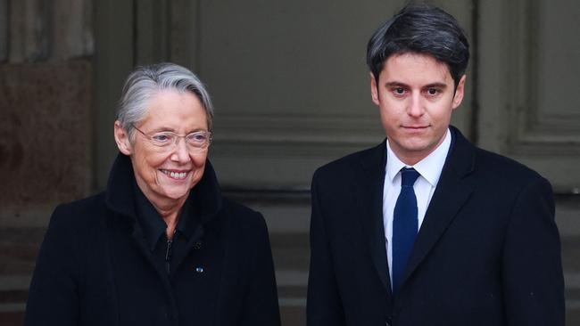 Gabriel Attal is welcomed by outgoing prime minister Elisabeth Borne as he arrives for the handover ceremony at the Hotel Matignon in Paris on Tuesday. Picture: AFp