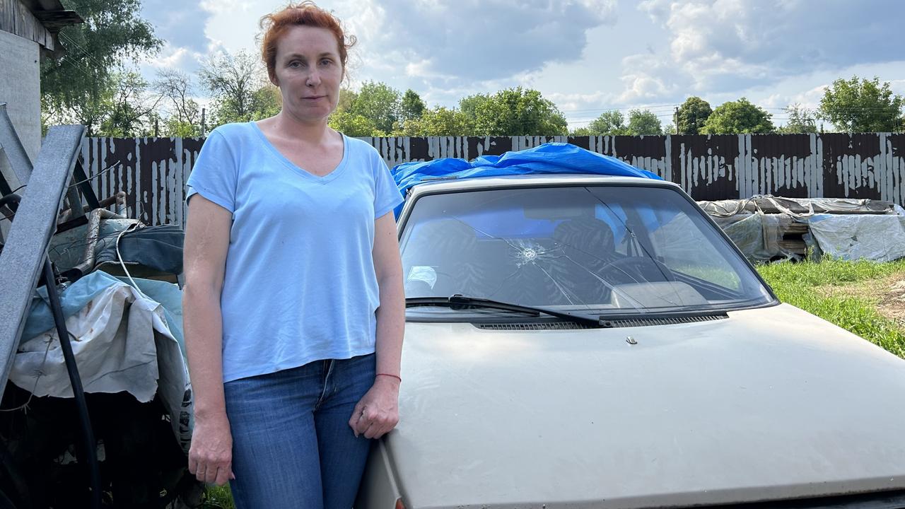 Oksana Serhiienko with the car she was driving when Russian soldiers shot at her.
