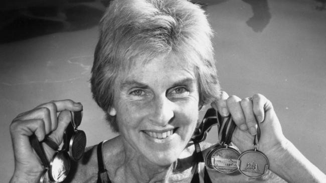 Denise Wangel (nee Norton) holding medals won at the 1989 Masters Games.