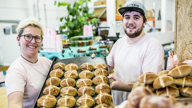 Head baker Jess Mackeen and baker Sam Saunders at Baked Gluten Free, Moonah with their Hot Happy Buns. Picture: EDDIE SAFARIK