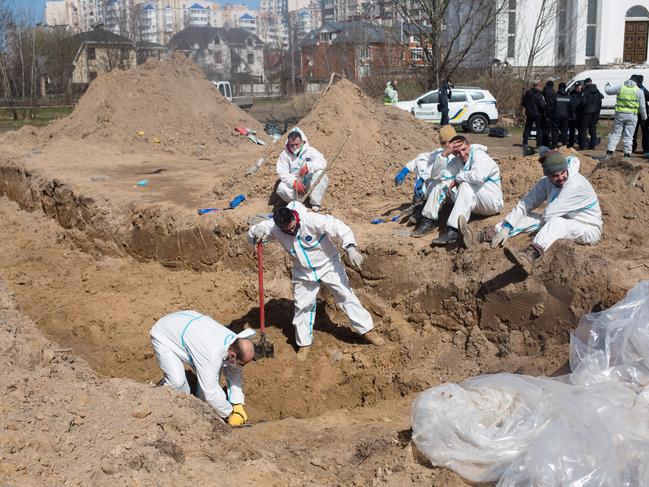 Members of the exhumation team work on a mass grave in Bucha, Ukraine. Picture: Anastasia Vlasova/Getty Images