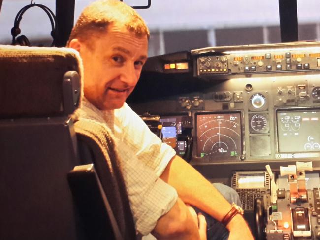 Michael Gilbert in a Boeing 777 simulator. The amateur aviation enthusiast has compiled a meticulous theory of what may have happened to MH370. Picture: Supplied