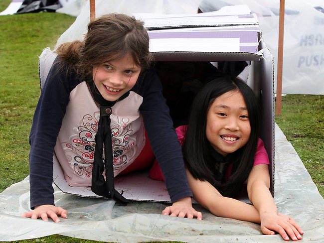 <p>Elise Chrisoulakis, 10, of Howden, with Marissa Chu, 10, of Blackmans Bay. crawling through the box tunnel. Picture: Kim Eiszele</p>