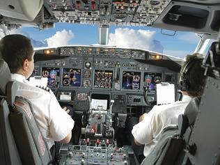 Generic image of pilots in the cockpit during a commercial flight of an aircraft.