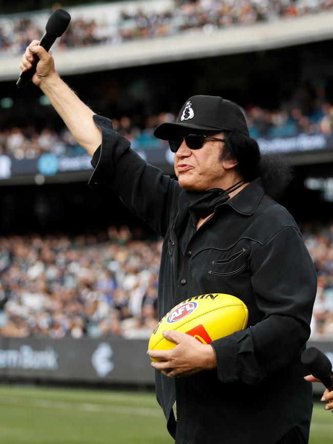 Carlton Blues fan Gene Simmons presents the match-day ball for the clash against the Collingwood Magpies at the MCG. Picture: Dylan Burns/AFL Photos via Getty Images