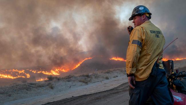 A firefighter communicates through a radio on the status of the Hughes Fire. Picture: Getty Images via AFP.