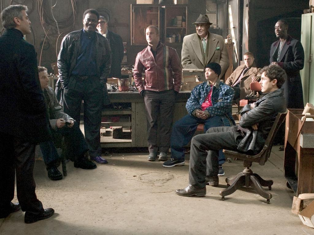 Actor George Clooney with Eddie Jemison, Bernie Mac, Elliott Gould, Scott Caan, Carl Reiner, Shaobo Qin, Brad Pitt, Casey Affleck, Don Cheadle and Matt Damon in a scene from film "Ocean's Twelve".