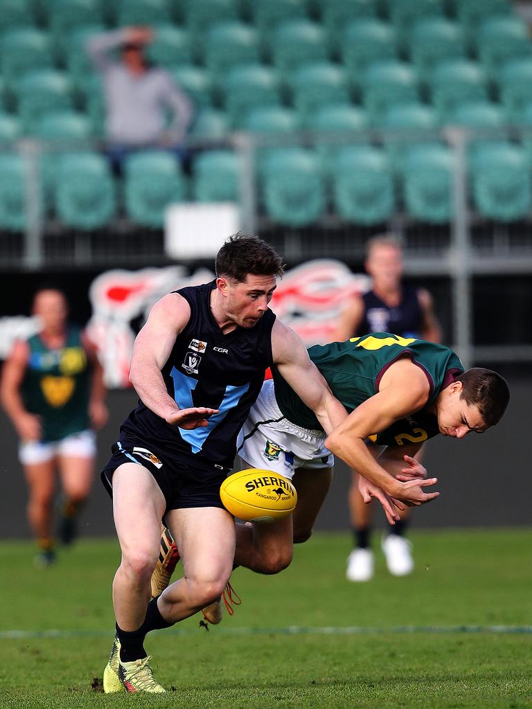 Tasmania Sherrin Egger and Vic Metro Jake Hobbs during the game against Vic Metro at UTAS Stadium. PICTURE CHRIS KIDD