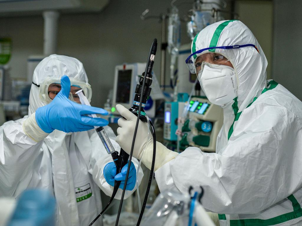 Doctors treating a patient infected by the COVID-19 coronavirus at a hospital in Wuhan. Picture: STR/AFP