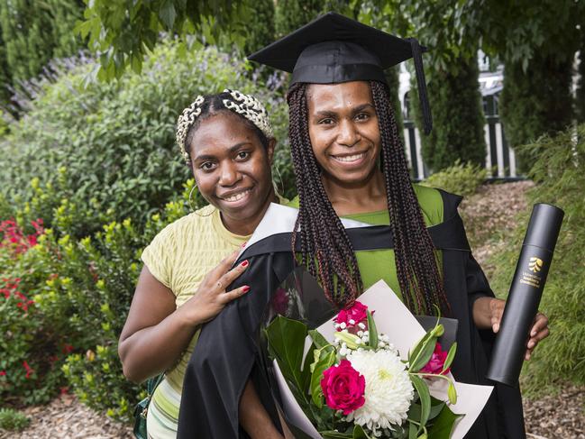 Elly Fafungian congratulates her sister, Yvonne Fafungian, on her Bachelor of Aviation graduation at a UniSQ graduation ceremony at Empire Theatres, Tuesday, February 13, 2024. Picture: Kevin Farmer