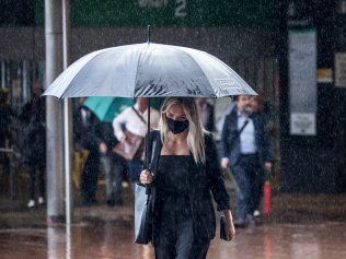 SYDNEY, AUSTRALIA - NewsWire Photos FEBRUARY 24:  Commuters pictured in the rain at Circular Quay after getting off a ferry.
Picture: NCA NewsWire / Damian Shaw