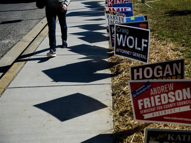 A man walks past campaign signs after early voting. Picture: AFP