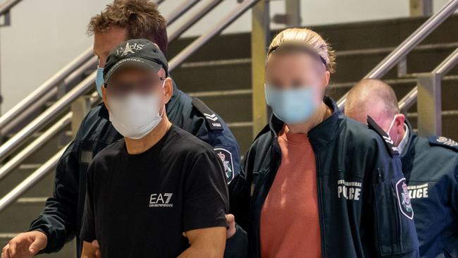 Australian Federal Police escort Chung Chak Lee at Melbourne Airport. Picture: Supplied.