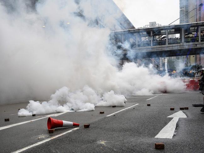 Protesters return tear gas towards the police in Tseun Wan in Hong Kong on August 25, 2019. Picture: AFP