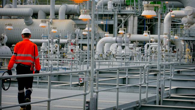 A worker walks through She’’’s Queensland Curtis Liquefied Natural Gas project in Gladstone.