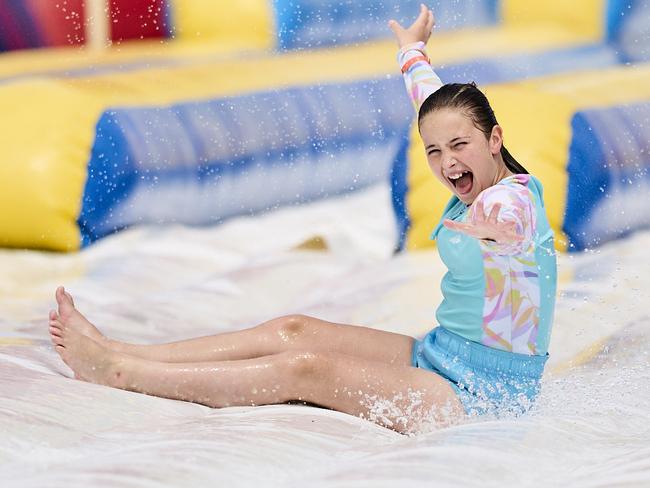 Friends, Chloe Mu, 10, and Adelaide Porter, 10 at The Big Wedgie Inflatable Water Park in West Beach, Sunday, Dec. 15, 2024. Picture: Matt Loxton