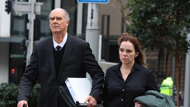 Rebecca Farrell, the sacked chief legal officer for Super Retail arrives at the Federal Court in Sydney with her lawyer. Picture: John Feder