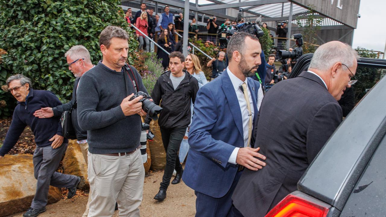 Trevor Sofield, the former high commissioner to Solomon Islands (far left) tried to speak with the Prime Minister this week, but Mr Morrison (far right) was bundled into a car and whisked away by security instead. Picture: Jason Edwards