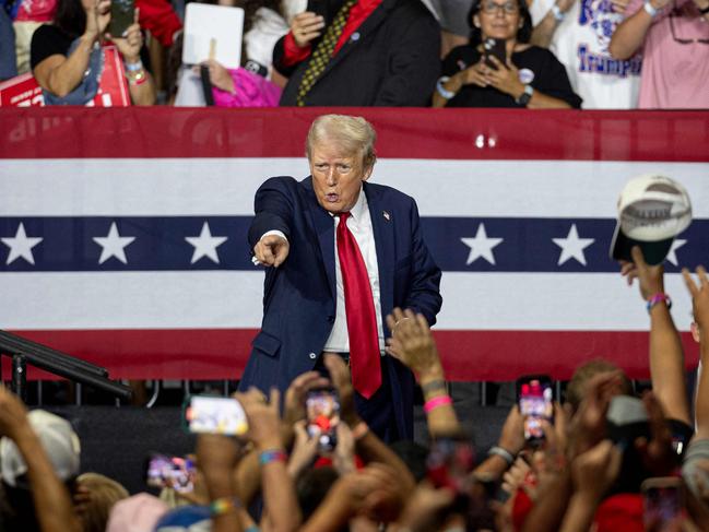 TOPSHOT - Former US President and 2024 Republican presidential candidate Donald Trump points to supporters in the crowd after speaking during a campaign rally at the Bojangles Coliseum in Charlotte, North Carolina, on July 24, 2024. (Photo by Logan Cyrus / AFP)