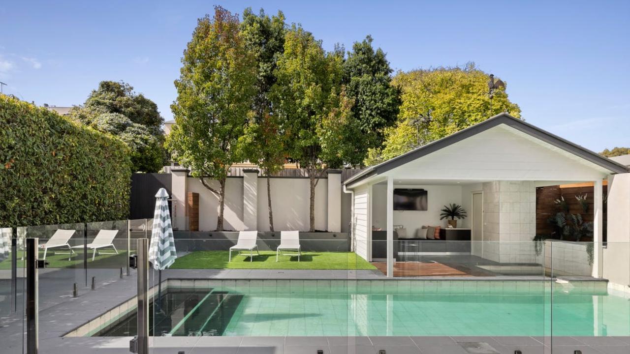 A gas and solar heated swimming pool, spa pavilion and commercial-grade outdoor kitchen create a resort-style backyard retreat.