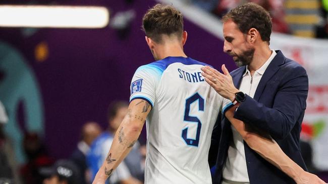 England's coach Gareth Southgate congratulates England's defender #05 John Stones as he is substituted during the Qatar 2022 World Cup round of 16 football match between England and Senegal. Picture: JACK GUEZ / AFP