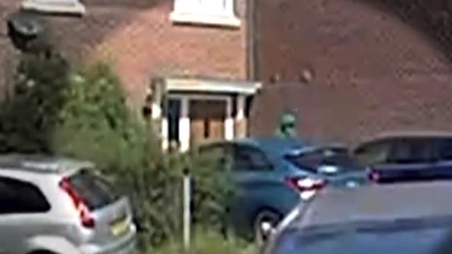 A Hooded and masked figure paces outside house 20 minutes before two children were stabbed to death at Taylor Swift-themed dance workshop - as footage shows armed police preparing to raid the same property hours laterCredit @PaulBrandITV