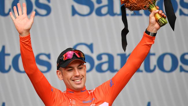 New Zealand’s Patrick Bevin  celebrates on the podium after retaining the leaders jersey following stage three of the 2019 Tour Down Under. Picture: Daniel Kalisz/Getty