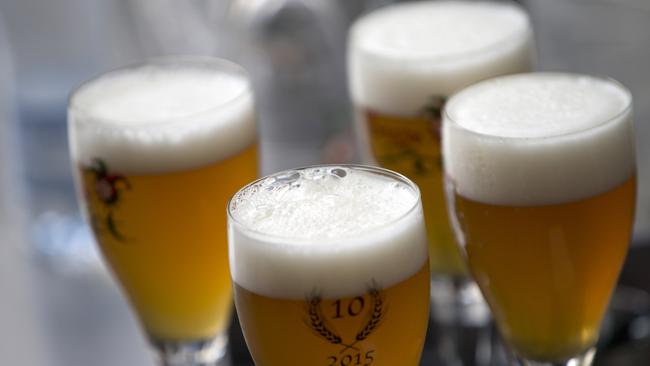 FILE - In this Thursday, May 26, 2016 file photo, glasses of beer stand on a serving tray in Bruges, Belgium. A university research survey has found that alcohol consumption in Belgium is remaining mostly stable during the country's coronavirus lockdown. A team of researchers at the University of Louvain said Wednesday, April 29,2020 that only one out of four respondents in their online survey this month reported drinking more while confined at home. (AP Photo/Virginia Mayo, File)