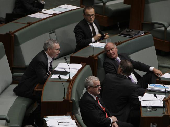 Craig Thomson talks with his cross bench colleagues during Question Time today in the House of Representatives, Federal Parliament, Canberra.