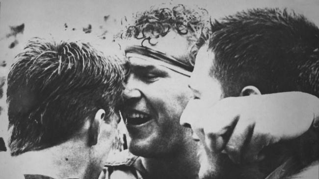 Tim Horan, Sam Scott-Young and Phil Kearns celebrate after the 1990 victory over New Zealand.