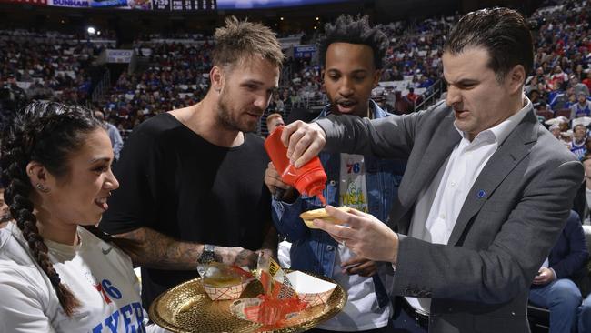 Dane Swan with a meat pie at a 76ers game