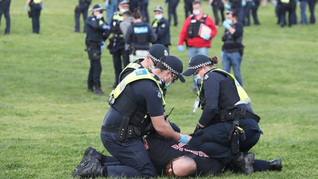 Protesters are swiftly tackled by officers. Picture: David Crosling