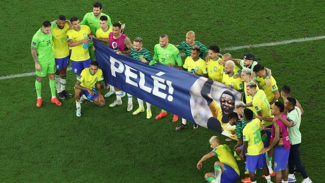 Brazil players hold a banner showing support for Pele after their Round of 16 win over South Korea. Picture: Getty Images