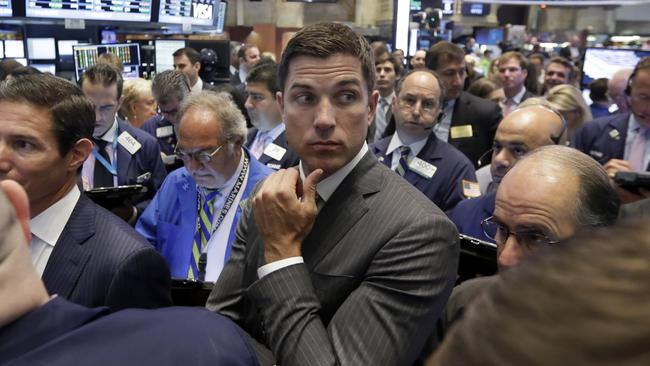 NYSE Group President Tom Farley, center, stands among traders on the trading floor, Wednesday, Aug. 5, 2015. U.S. stocks are rising in early trading, shaking off a three-day slump, as the latest round of company earnings news brought several positive surprises. (AP Photo/Richard Drew)