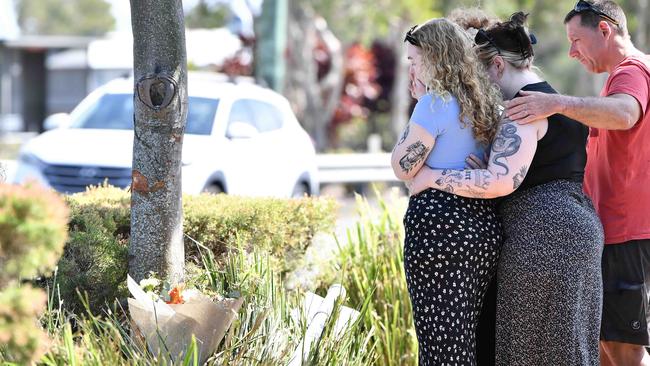 A Qld family has shared their heartbreak after a young man was killed in a freak crash while working on a roadside, Mooloolaba. Pictured, fiancee Lucy Milward (blue top) with family and friends. Photo: Patrick Woods.