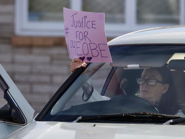 Mandy Louise Hart with her sign outside Bundaberg Court House where Tanika Bromley and James Wood have appeared charged for the murder of Pheobe Bishop. Picture: Liam Kidston.