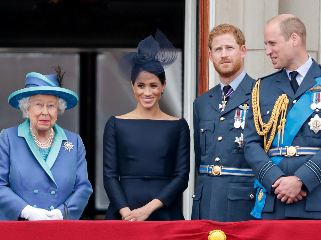 LONDON, UNITED KINGDOM - JULY 10: (EMBARGOED FOR PUBLICATION IN UK NEWSPAPERS UNTIL 24 HOURS AFTER CREATE DATE AND TIME) Queen Elizabeth II, Meghan, Duchess of Sussex, Prince Harry, Duke of Sussex, Prince William, Duke of Cambridge and Catherine, Duchess of Cambridge watch a flypast to mark the centenary of the Royal Air Force from the balcony of Buckingham Palace on July 10, 2018 in London, England. The 100th birthday of the RAF, which was founded on on 1 April 1918, was marked with a centenary parade with the presentation of a new Queen's Colour and flypast of 100 aircraft over Buckingham Palace. (Photo by Max Mumby/Indigo/Getty Images)
