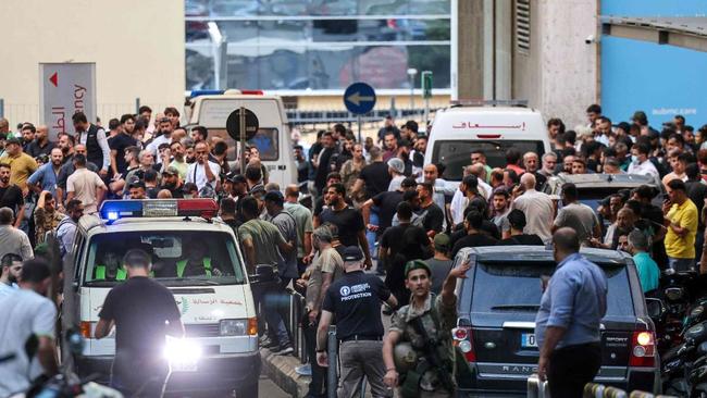 Ambulances are surrounded by people at the entrance of the American University of Beirut Medical Center after Hezbollah members' pagers simultaneously exploded in Lebanon. Picture: AFP