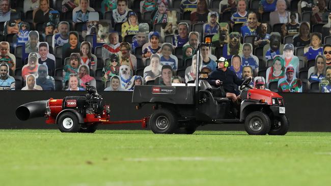 A member of the Bankwest ground staff dries the field during round 7. Picture: Mark Kolbe/Getty