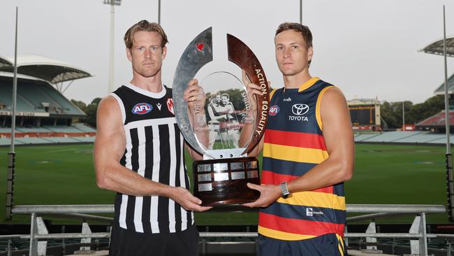 Adelaide Crows Captain Jordan Dawson and Port Adelaide Captain Tom Jonas with the Showdown Trophy at Adelaide Oval. NewsWire / David Mariuz