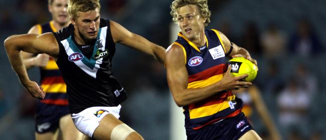 Port Adelaide’s Jackson Trengove hunts Adelaide’s Myke Cook.