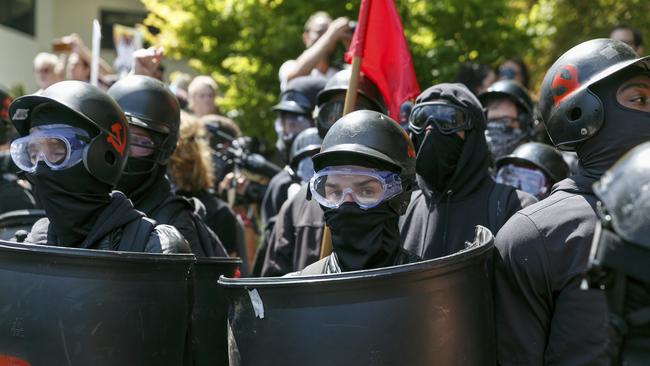 Counter-protesters prepare to clash with Patriot Prayer protesters during a rally in Portland, Ore., Saturday, Aug. 4, 2018. Small scuffles broke out Saturday as police in Portland, Oregon, deployed "flash bang" devices and other means to disperse hundreds of right-wing and self-described anti-fascist protesters.(AP Photo/John Rudoff)