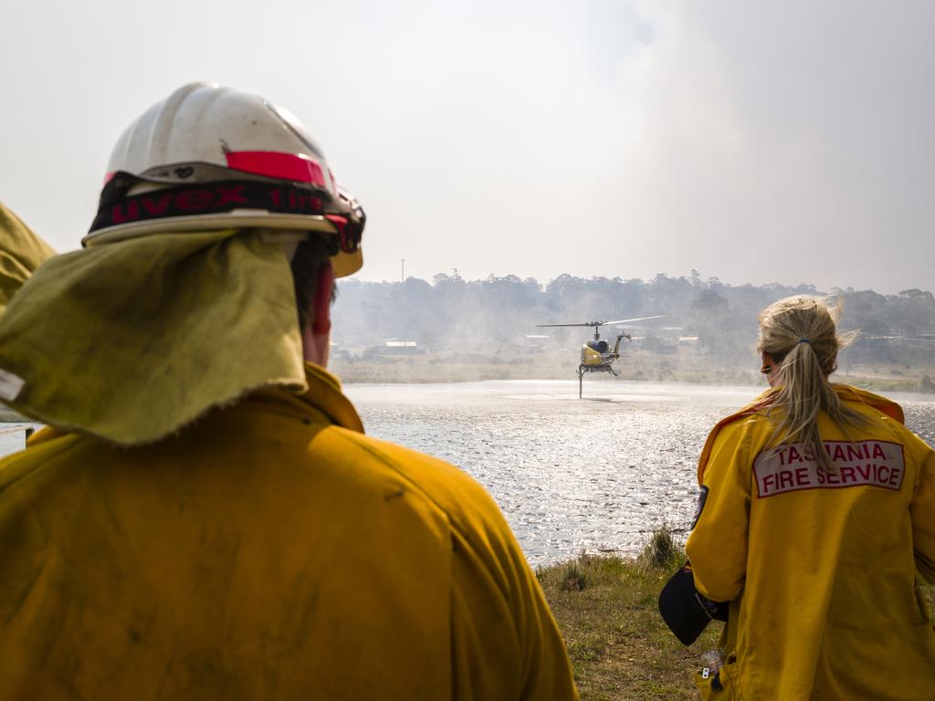 A water-bombing helicopter fills up at Great Lake. Picture: Heath Holden/Getty