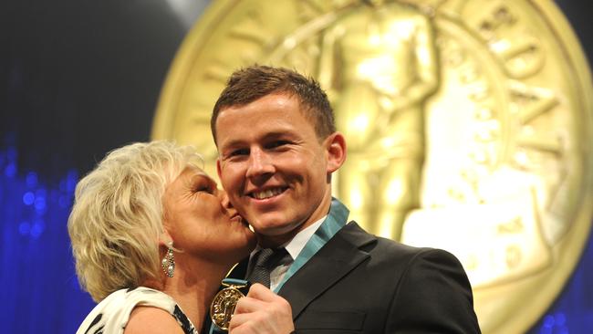 Todd Carney kissed by his mother Leanne Carney after winning the 2010 Dally M Medal. Photo: AAP Image/Tracey Nearmy