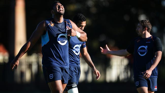 Taqele Naiyaravaro (L) finds time at Waratahs training at Moore Park to have a laugh with teammates.