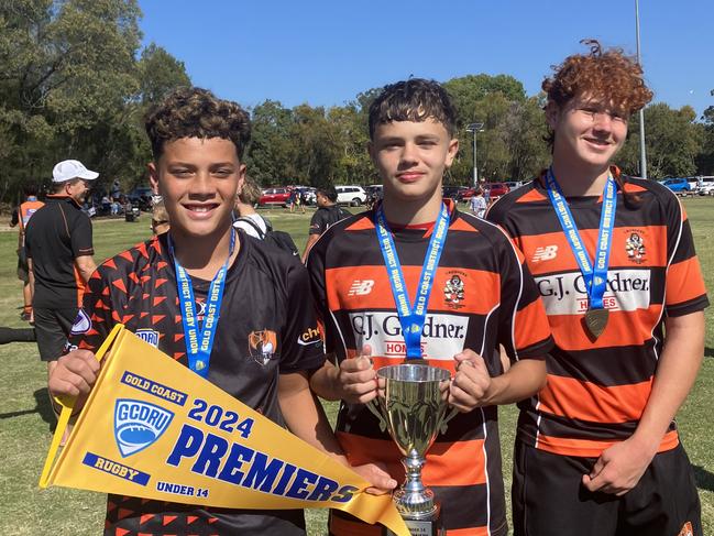 Coomera Crushers players Colten-Amotawa Pohe, Brody Lanini and Bradley Ramsay-Cameron celebrate their side's under-14 GCDRU grand final win. Picture: Mitch Bourke.