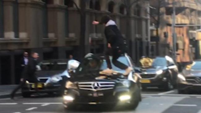 Ney jumps on to the bonnet of a Mercedes in the city. Picture: Seven News